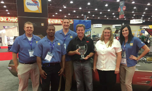 Members of the BASF Automotive Refinish team accepting the top custom car award with Chip Foose. From left to right: Justin Griffin, BASF Sales Development Intern; Marcus Grant, BASF Sales Development Intern; Steve Shemanski, BASF Customer Care Representative; Chip Foose; Tina Nelles, BASF Marketing Services Manager and Kate Kalahar, BASF Customer Care Representative