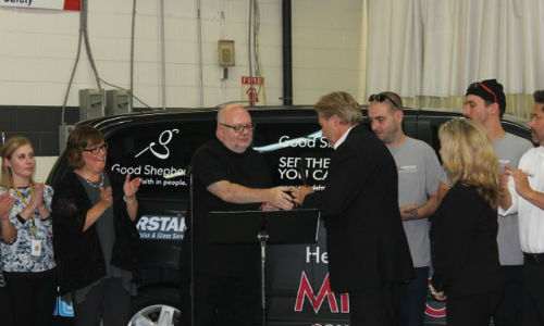 Rick Yates (right) hands over the key to the refurbished van to Brother MacPhee, Executive Director of Good Shepherd.