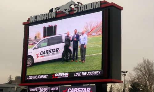 Calgary CARSTAR owners present the new Community Cruiser to Calgary Sports & Entertainment at McMahon Stadium in Calgary.