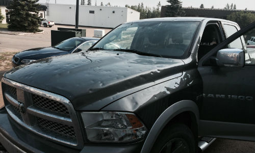 A hail-damaged vehicle in Red Deer, Alberta. There is evidence that hail storms are increasing in severity, leading to a greater need for PDR technicians.