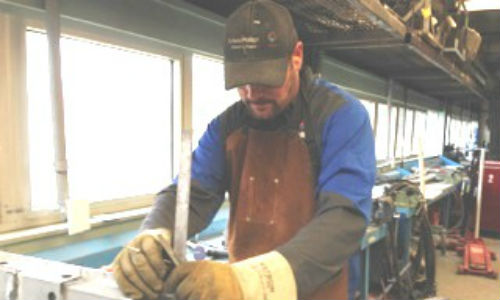 Troy Copeland of CSN-Dana's Collision Center sets up a test weld during his certification.