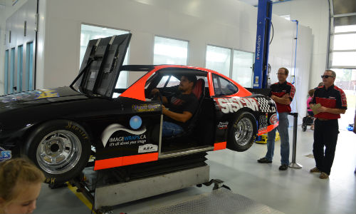 A full-motion race car simulator helped draw the 800-plus crowd for CSN-Hutten Collision's fundraising Open House