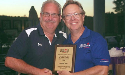 Speedy Collision CEO Terry Allen accepting the title sponsorship plaque from Crime Stoppers of Halton Chair Doug Maybee.