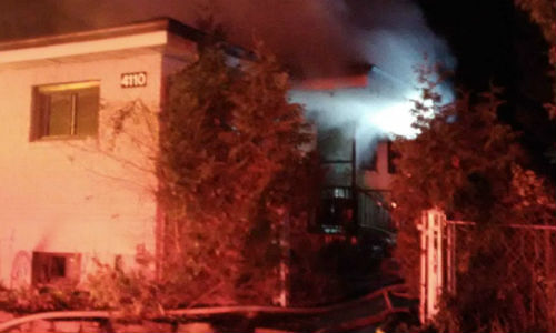A blaze broke out at a house attached to Leitrim Body Shop in Ottawa. Photo by Scott Stilborn/Ottawa Fire Services.
