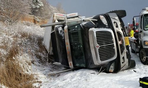 An upturned truck lies in a ditch after a massive crash along the 401. More than 100 vehicles were involved in the incident.
