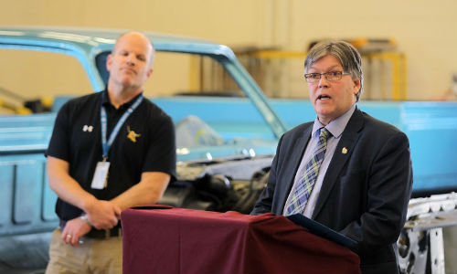 Manitoba’s Education and Training Minister, Ian Wishart, announced that the province would commit $347,453 to Crocus Plains Regional Secondary School’s collision program. The school’s principal is Chad Cobbe (right). Photo by the Brandon Sun.