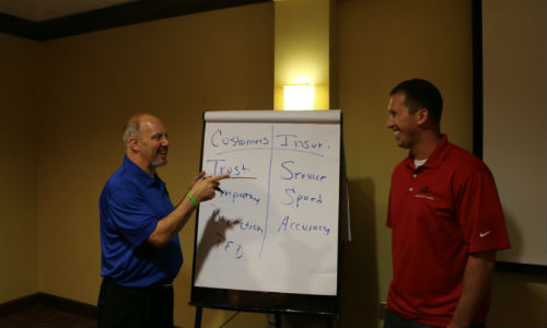 Mike Anderson (left) and Gary Gardella Jr. during a training session at Axalta's Refinish Performance Management seminar in 2015. Anderson will serve as the guest of the next Guild 21 Conference Call.