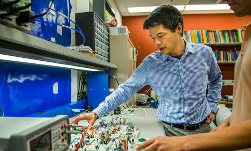 Kevin Fu of the University of Michigan shows how acoustic waves can interfere with the data that certain accelerometer sensors are monitoring. These sensors are found in a wide variety of technologies, including AVs. Photo by Joseph Xu, Michigan Engineering.