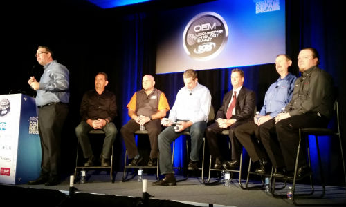 SCRS Executive Director Aaron Schulenburg (left) introduces an aftermarket scan tool panel at the OEM Collision Repair Technology Summit at SEMA in 2016. Photo by John Huetter of Repairer Driven News.