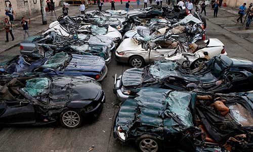 A pile of crushed luxury vehicles in the Philippines.