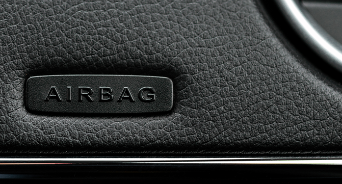 a close-up shot of a clean but texture car dashboard; focused on an emblem reading 'label'